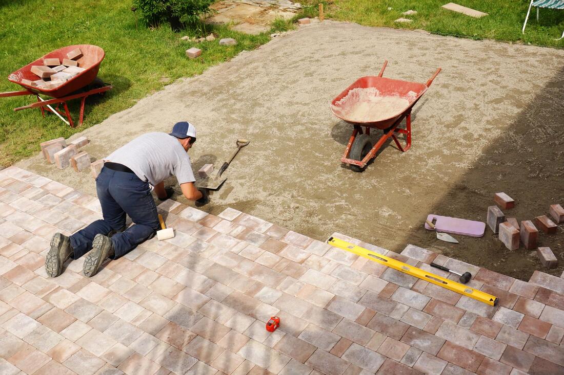 man installing brick floorings